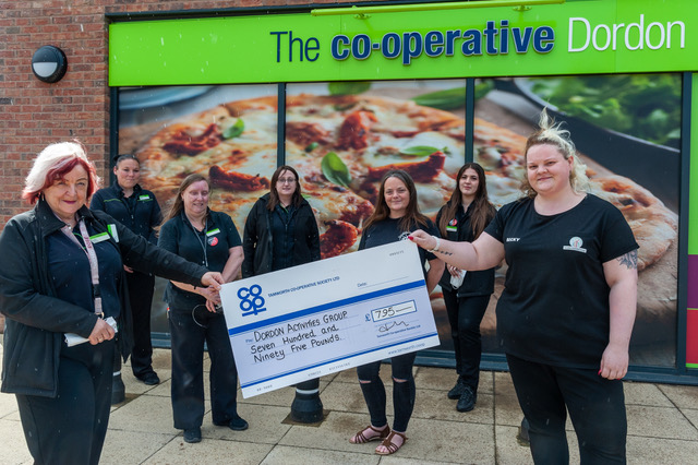 ordon Co-op manager Annette Brindley (left) presents Becky Guild, a volunteer with the Dordon Activities Group, with a cheque for £795 from the Community Dividend Fund. Also pictured are other team members from the Dordon Co-op and Katrina Melia (third from right), another volunteer from the Dordon Activities Group.